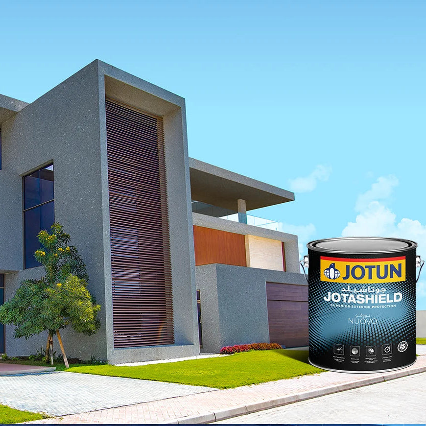 Modern house with Jotun Jotashield paint can in the foreground